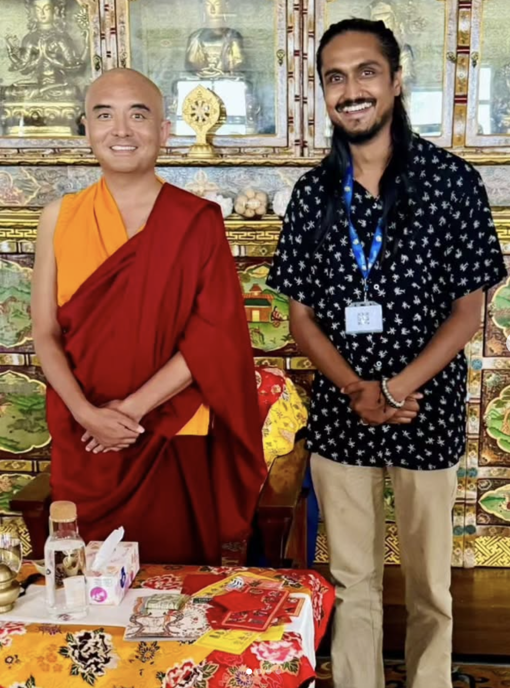 Portrait with Buddhist monk in front of ornate golden altar