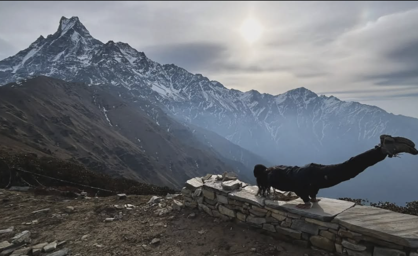 Mountain stretching pose with snow-capped peaks